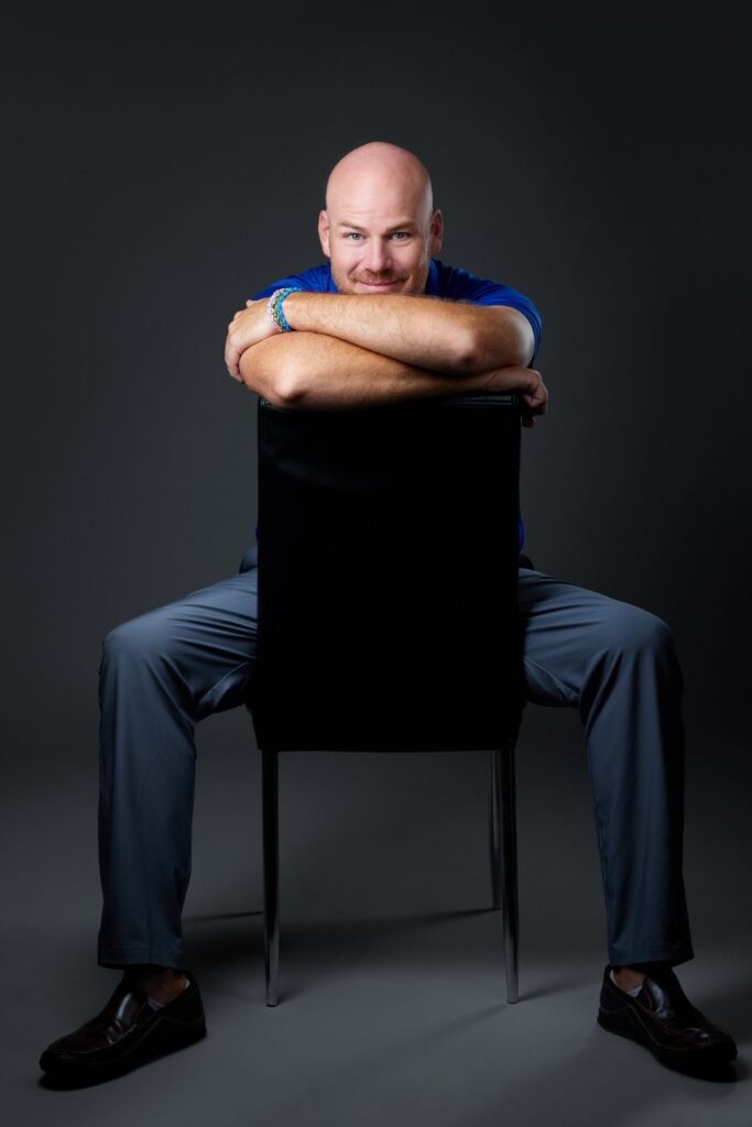Grant Clayton sitting in a chair backwards